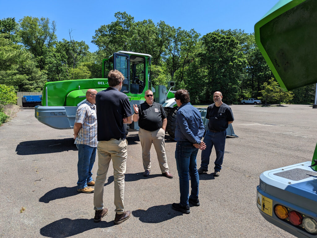 HEVI employees answering questions about electric heavy equipment